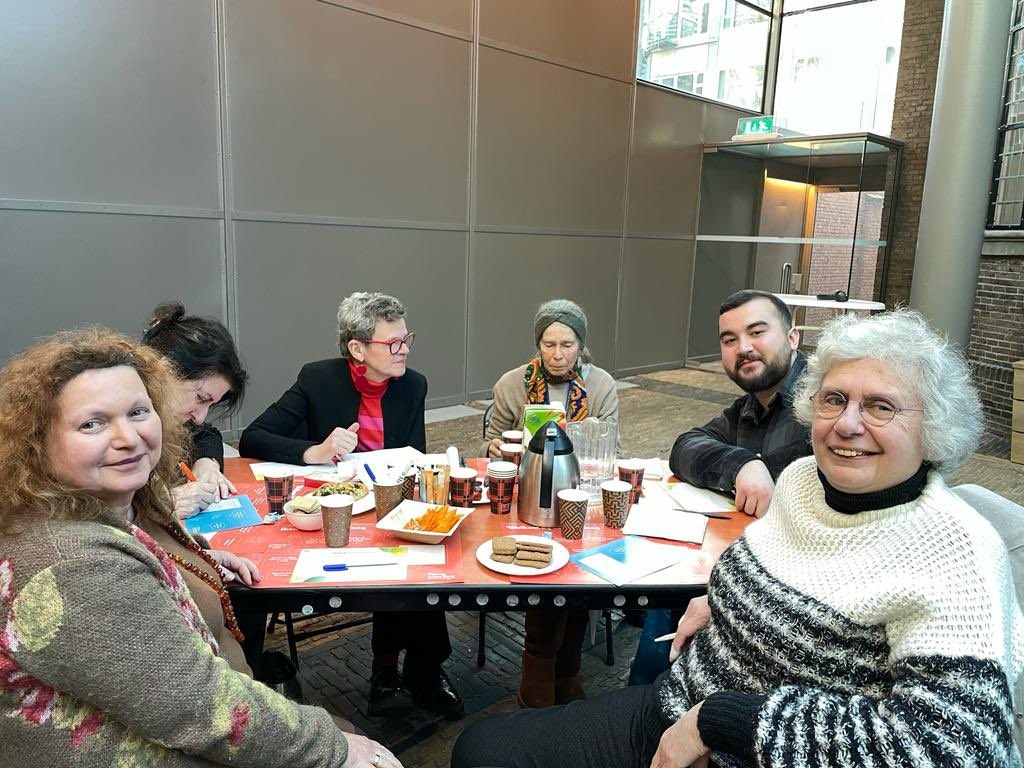 Deelnemers aan tafel bij het bezoek aan de synagoge